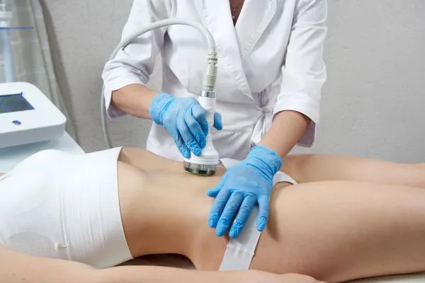 Lost the Weight but Not the Loose Skin? 2 woman having HIFU treatment on her stomach to combat loose skin Shoreham by Sea following weight loss